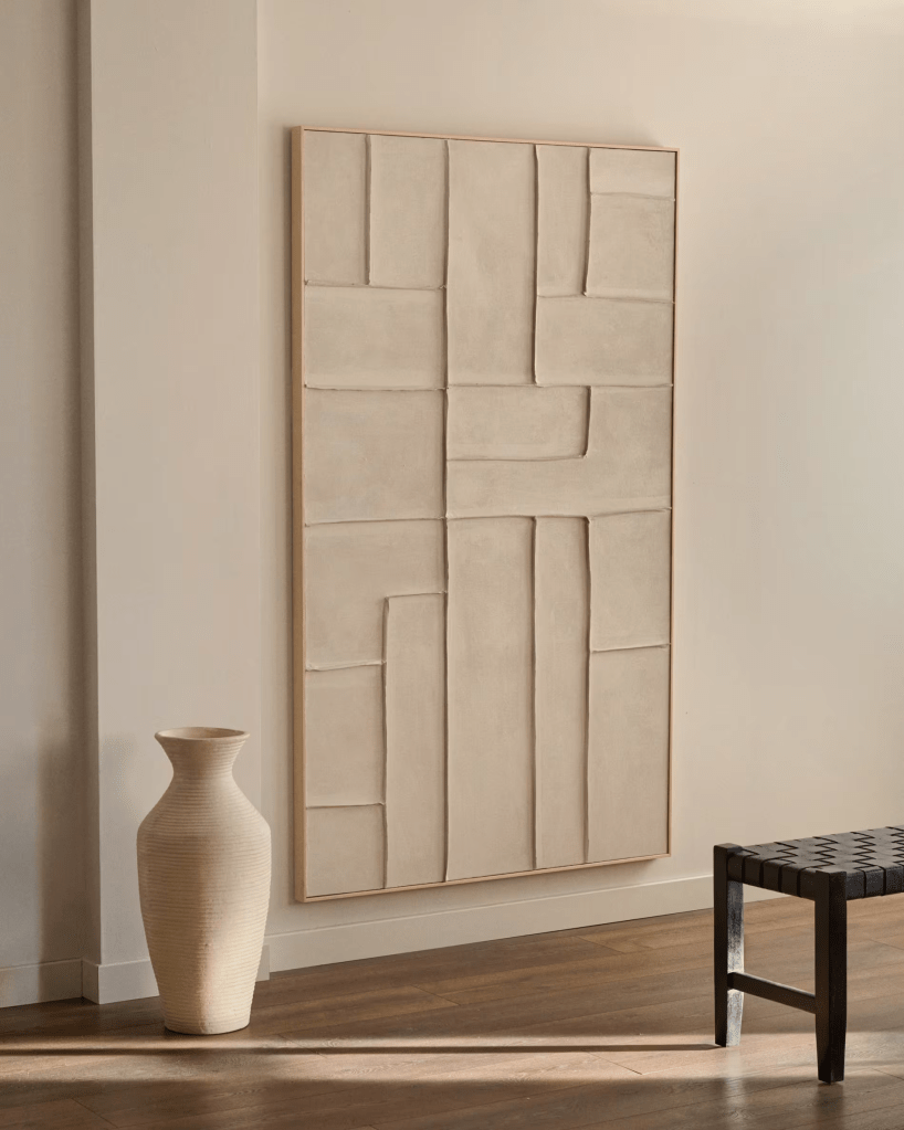 Minimalist living room with neutral tones featuring textured wall art and wooden furniture from Kave Home