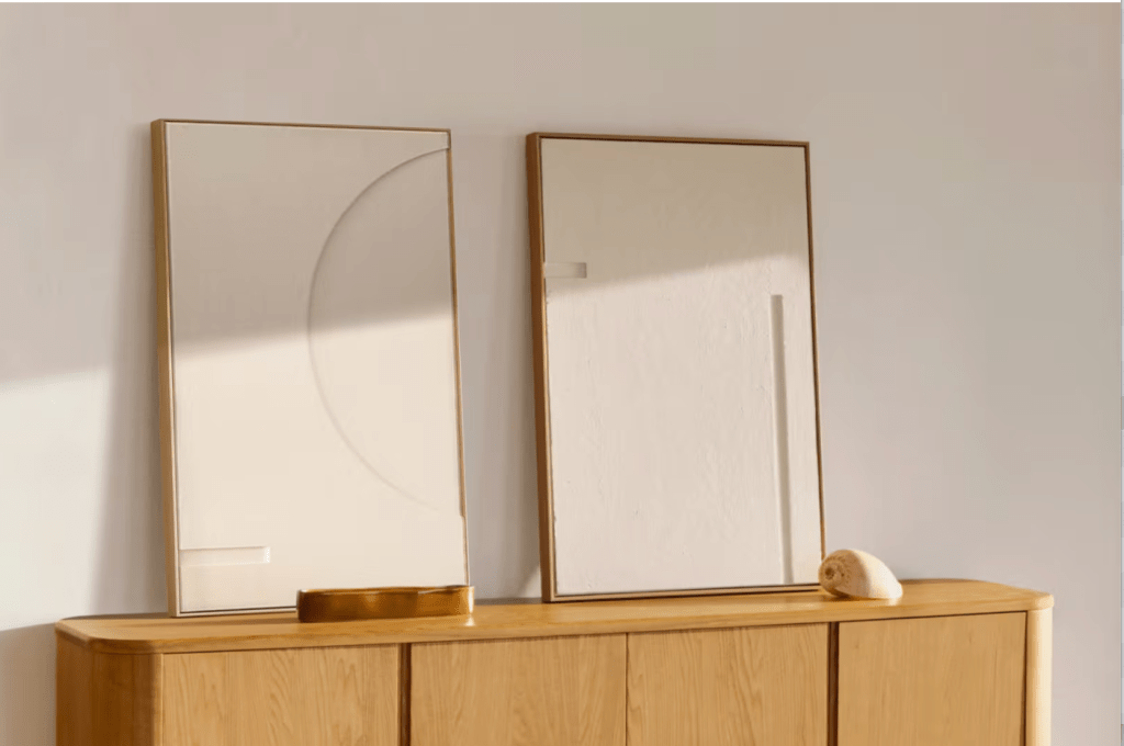 Set of two minimalist white-framed textured wall art pieces from Kave Home, styled in a neutral-toned interior